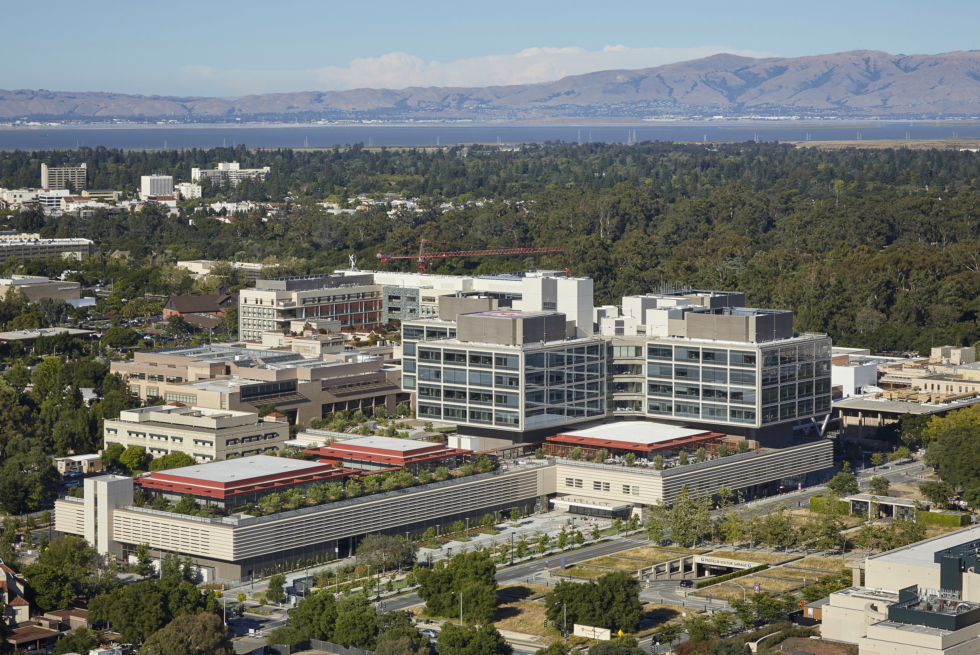 The New Stanford Hospital, exterior aerial view with mountains and water in the background