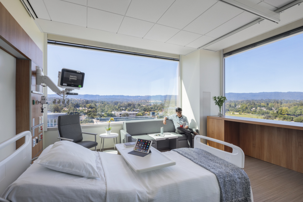 A corner patient room in the New Stanford Hospital, with large windows overlooking the water.